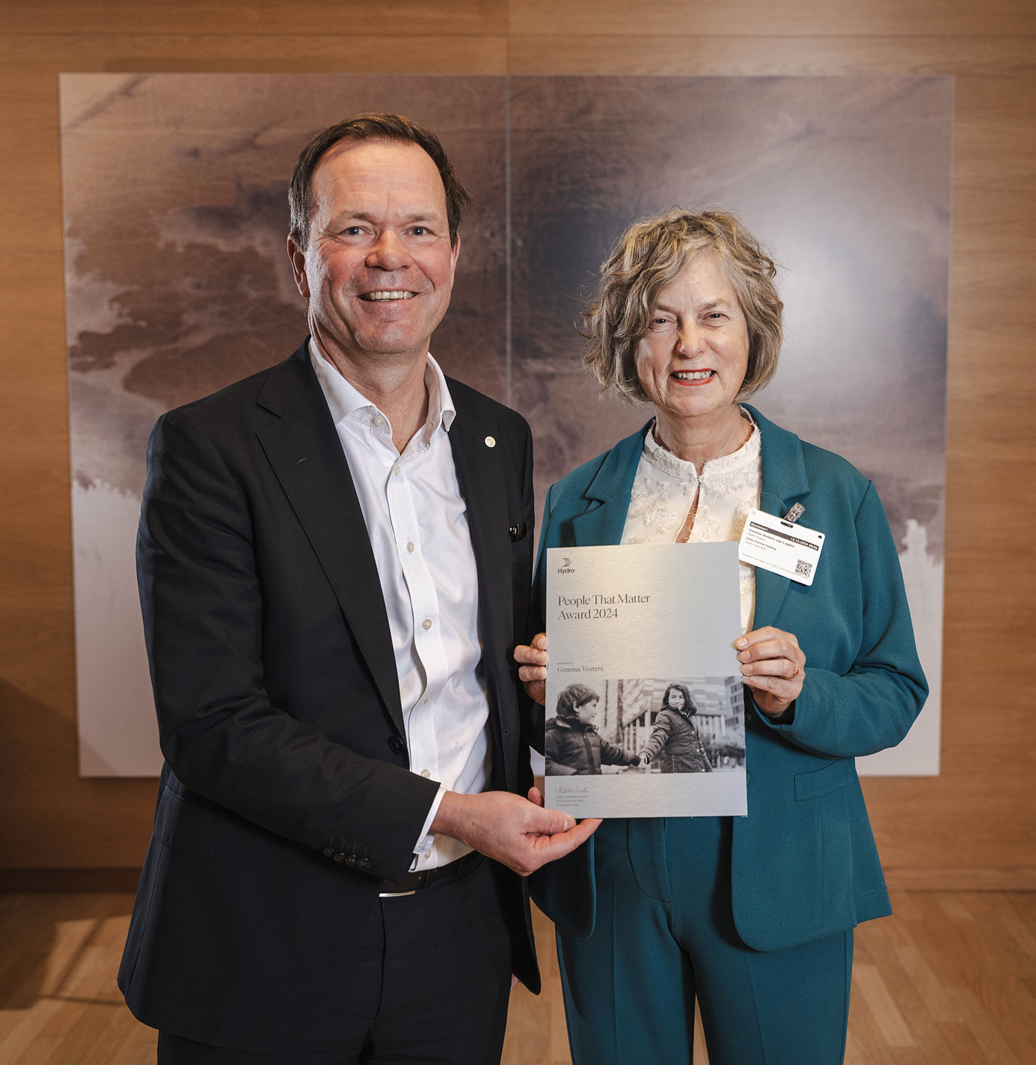a man and a woman holding a framed picture