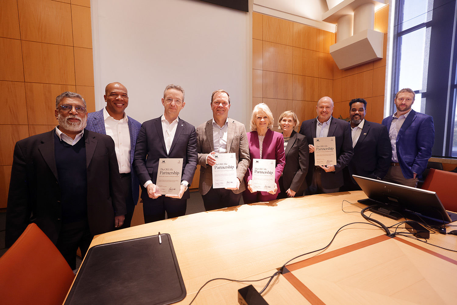 a group of people holding certificates
