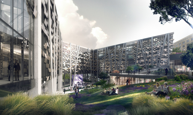 a group of people sitting on the grass in front of a building