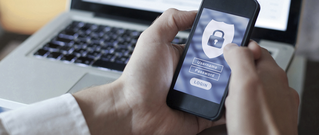 Hands holding smartphone with login screen